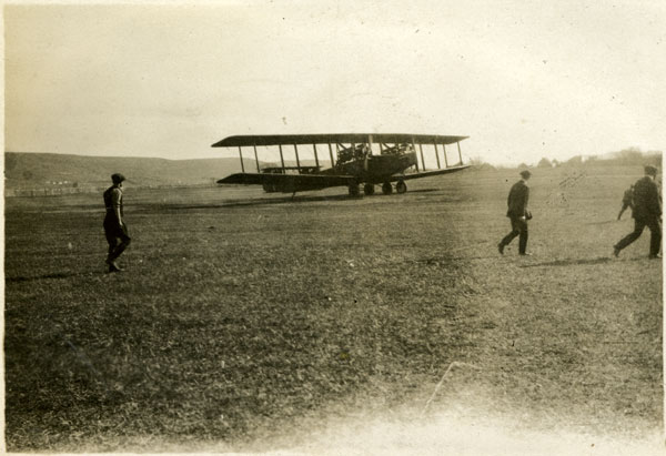 The Atlantic sitting in the runway and three men in the foreground.