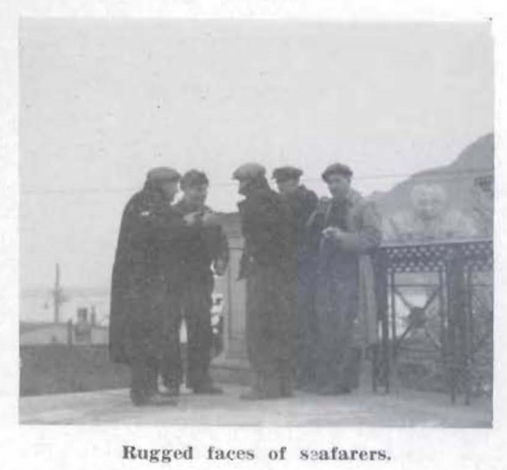 A group of five Newfoundland men talking in a circle, with one looking at the camera. They are wearing long, heavy coats and salt n' pepper caps. The caption from the book reads: "Rugged faces of seafarers."